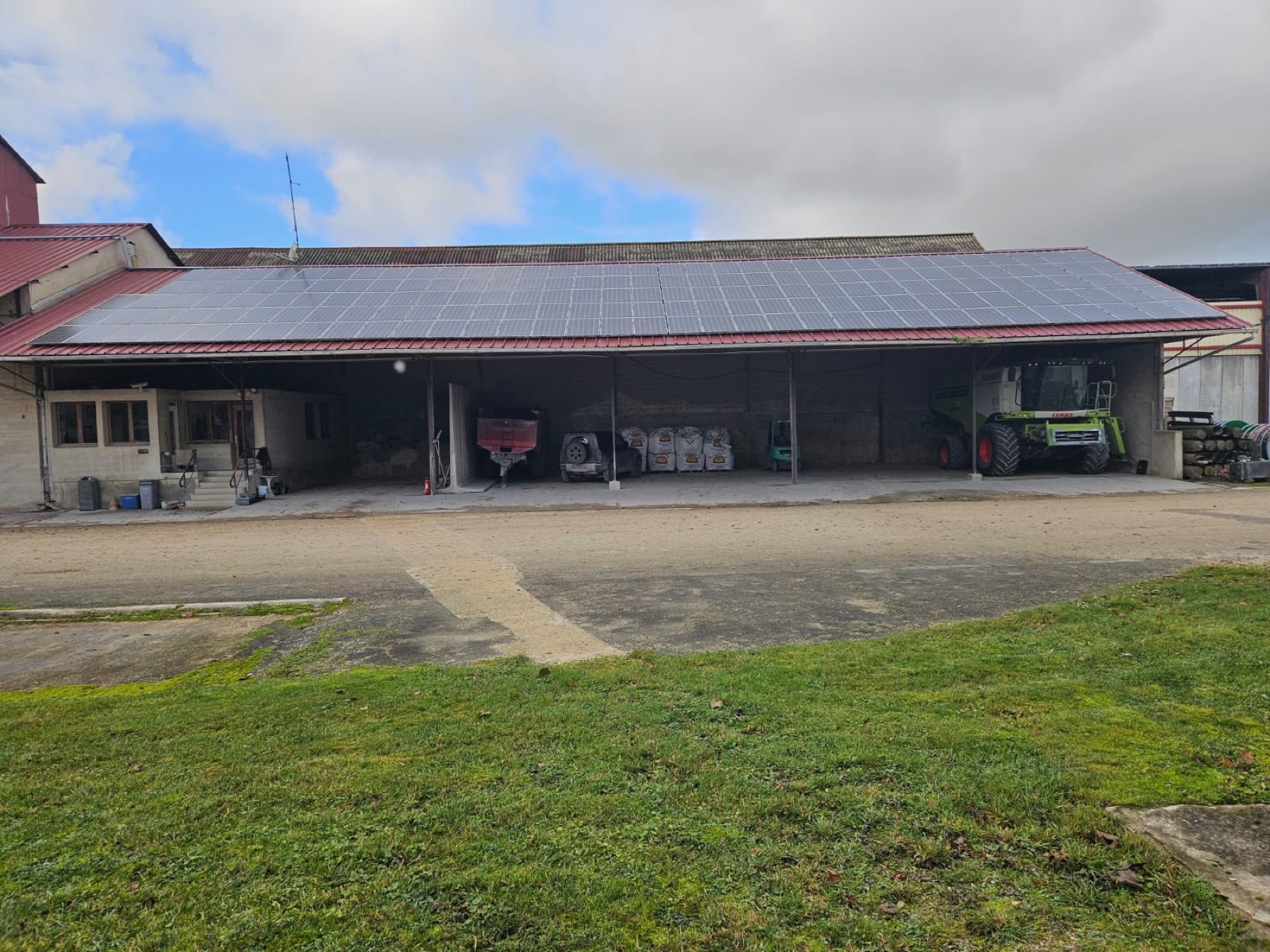 Farm equipment under a photovoltaic agricultural roof